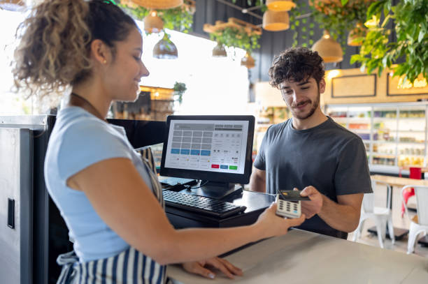 Man making a contactless payment at a coffee shop