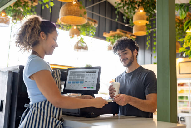 istock Happy man making a contactless payment at a coffee shop 2193787928
