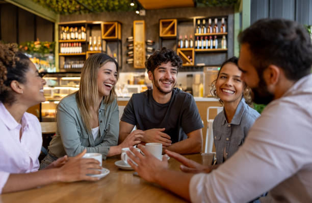 istock Happy group of friends drinking coffee at a cafe 2193788015