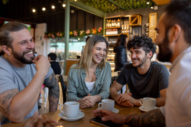 istock Happy group of friends laughing at a cafe 2193788016