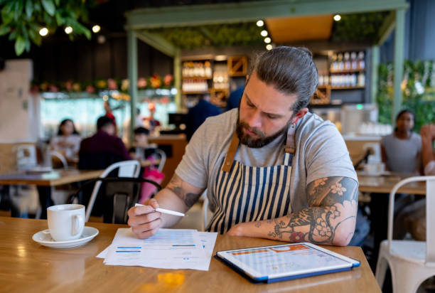 istock Business manager doing the books at a coffee shop 2193788019