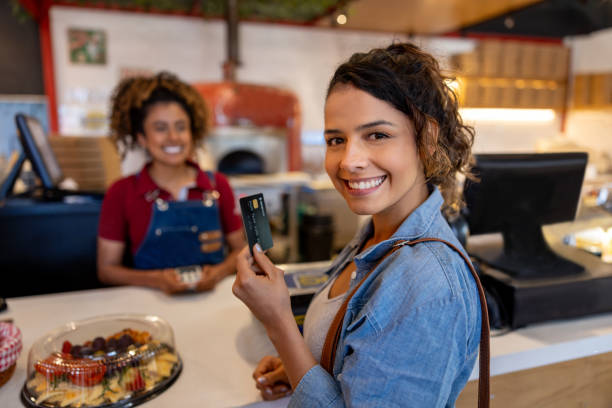 istock Woman paying by card while shopping at a delicatessen 2193788050