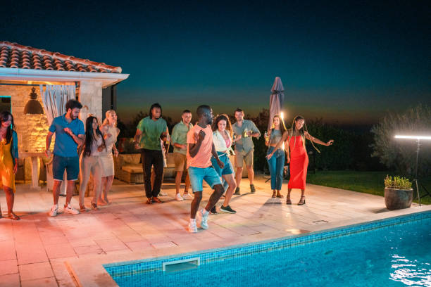 istock Joyful Friends Celebrating by the Pool at Night 2193789496