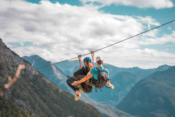 istock Caucasian Couple Experiencing Elevated Zipline Thrills With Premium Safety Equipment 2193790232