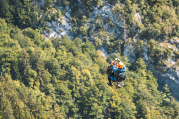istock Young Peak-bound Thrill-seekers Soar Blending Mountain Majesty With Adrenaline-fueled Zipline Excitement 2193790235