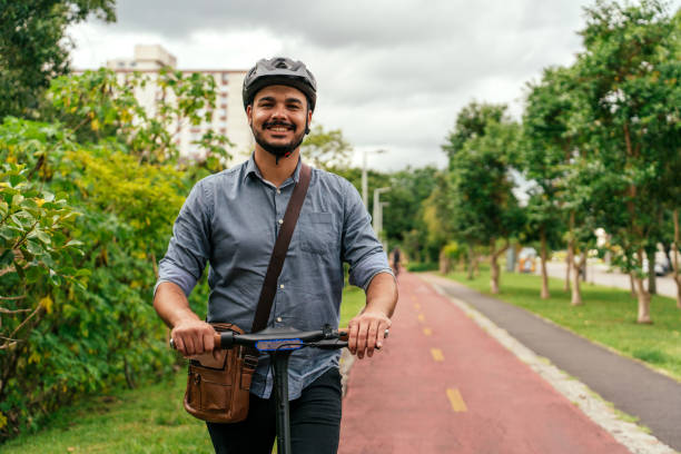 Portrait of worker using electric scooter in city