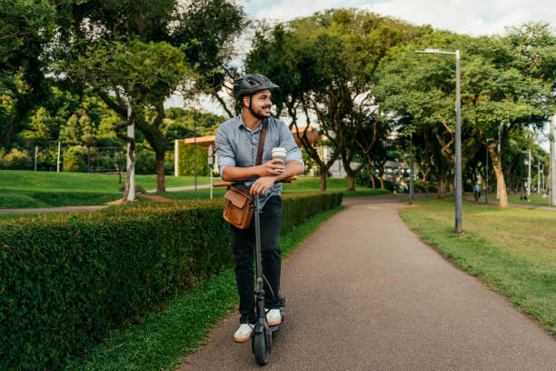 Businessman going to work on electric scooter