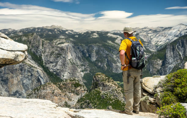 Hiker Pauses To Look Down Into The Valley Below Dewey Point in Yosemite