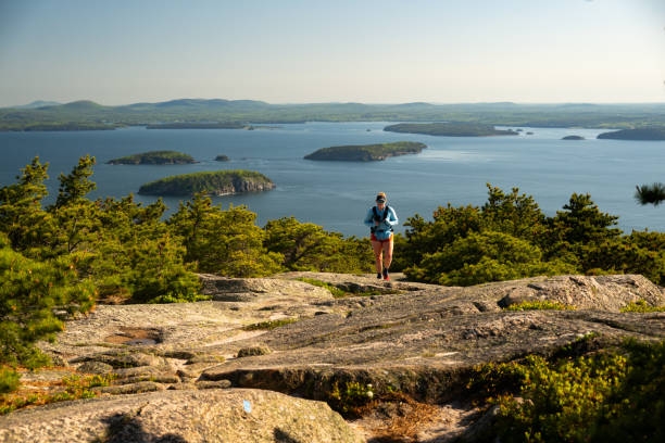 istock Woman Hikes Uphill on Granite Trail in Acadia 2193792011