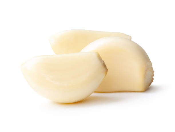 istock Side view of peeled pounded garlic cloves or pieces in stack isolated on white background with clipping path 2193793563