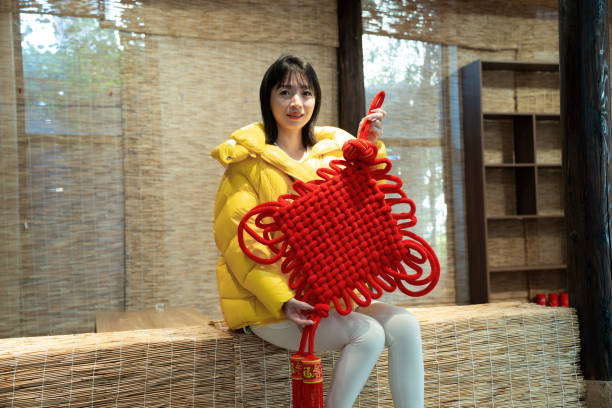 Woman holding Chinese New Year decorative items in hand