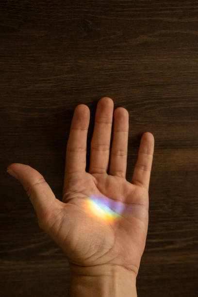 istock Close Up of Hand with Rainbow Reflection 2193796515