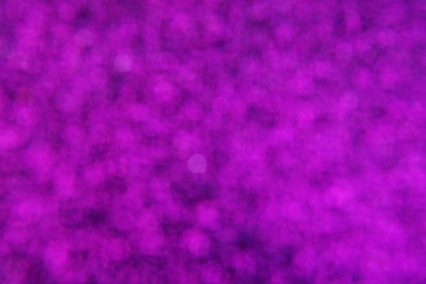 Abstract defocused shiny sparkle purple glitter bokeh background
