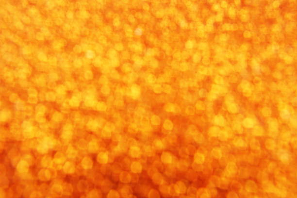 Abstract defocused shiny sparkle gold glitter bokeh background