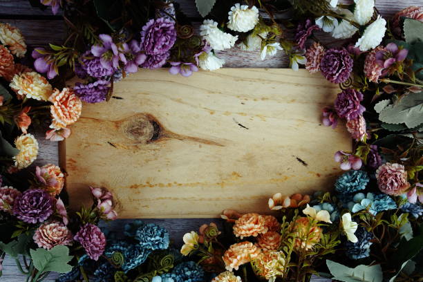 istock Beautiful flowers frame decoration with space for text message top view on wooden background 2193797517