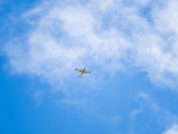 istock Small ultralight airplane with overhead wing and single propeller flying in sunset sky. 2193797538