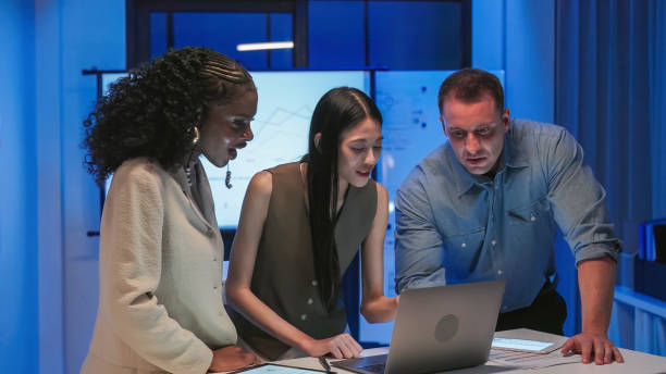 istock Diverse Collaborative Business people meeting with Digital Devices computer brainstorming the financial report paperwork document analyzing data or planning strategies displays a graph or chart in a modern business technology  at night 2193800404