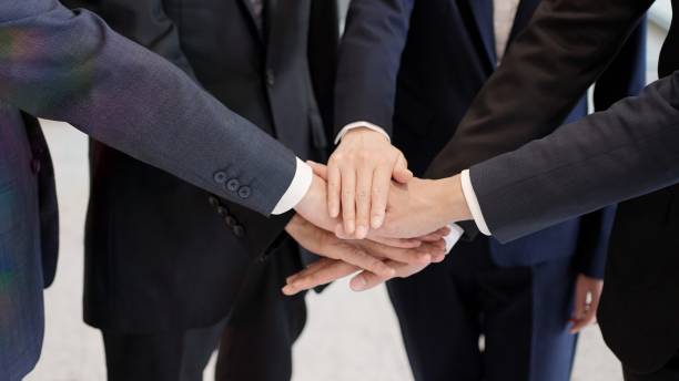 The hands of a business person clasping their hands together stock photo