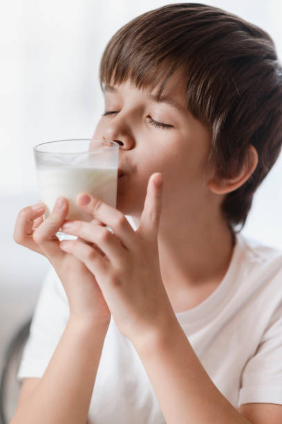 istock The boy really likes to drink milk at home 2193810321