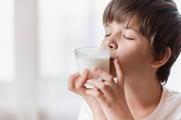 istock The boy really likes to drink milk at home 2193810502