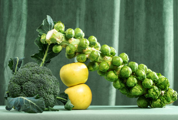 Still life of green vegetables and fruits on a green background