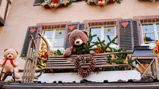 Festive decorations, teddy bear ornaments on historic half timbered houses, during the Christmas Market in Strasbourg, France