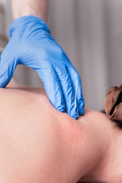 istock Physiotherapist treats a patient 2193815714
