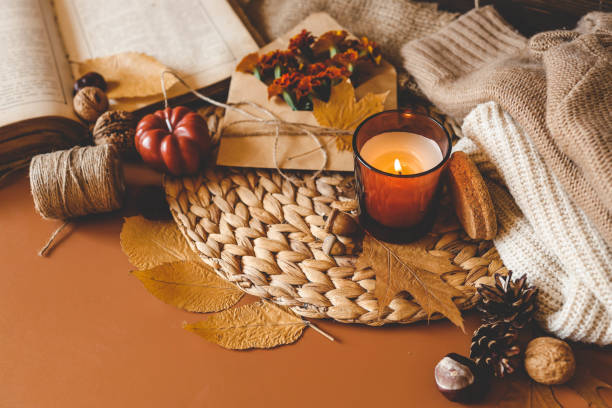 istock Burning candle in a cozy warm homey autumn atmosphere 2193815754