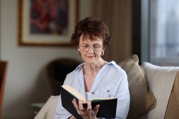 istock Senior woman at home reading a book 2193816428
