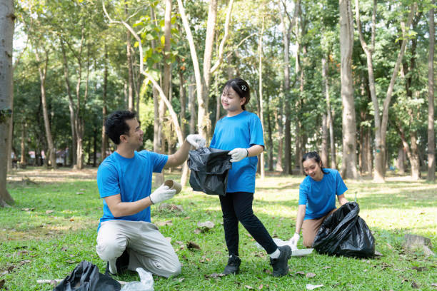 istock Family enjoying a collaborative garbage collection effort in a beautiful park 2193817373