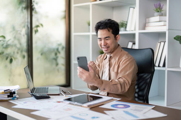 istock Business success unveiled a young professional engages on smartphone in modern office environment 2193817603