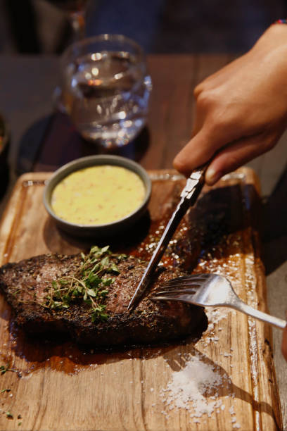 istock Unrecognizable person cutting steak at high end restaurant. 2193818450