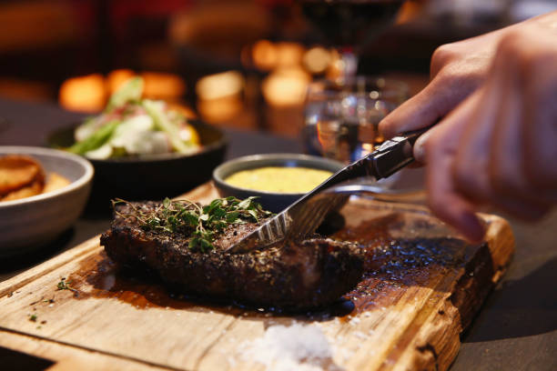 istock Unrecognizable man eating steak alone at high end restaurant 2193818462