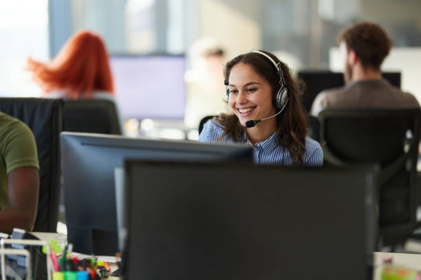 istock Happy female customer service representative working on PC in the office. 2193818644