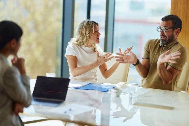 istock Frustrated couple arguing during a meeting with their agent in the office. 2193819074