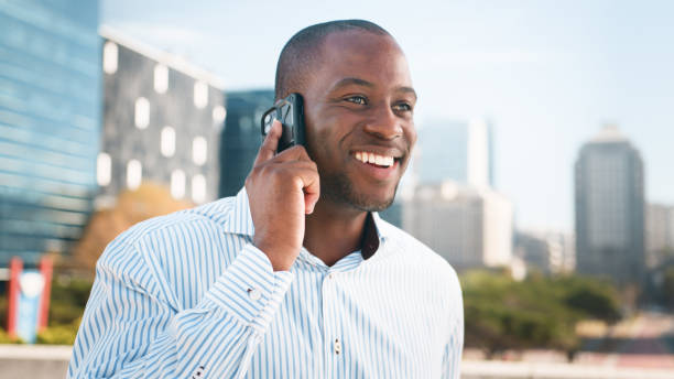 istock Cheerful Businessman Talking on Phone Outdoors in a Modern Urban Setting 2193819994