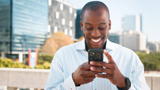 istock Smiling Young Professional Using Smartphone Outdoors in Modern Urban Environment 2193820645