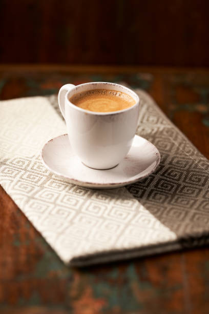 Cup of coffee on dark wooden background. Copy space.