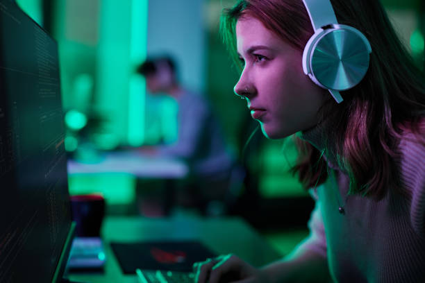 istock Focused woman playing a video game on desktop PC. 2193824163