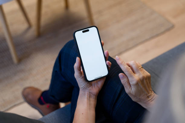 istock Senior adult using smartphone with blank screen at home 2193825459