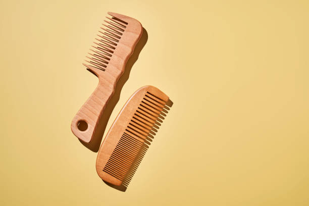 istock Two wooden combs on a yellow background. 2193827541