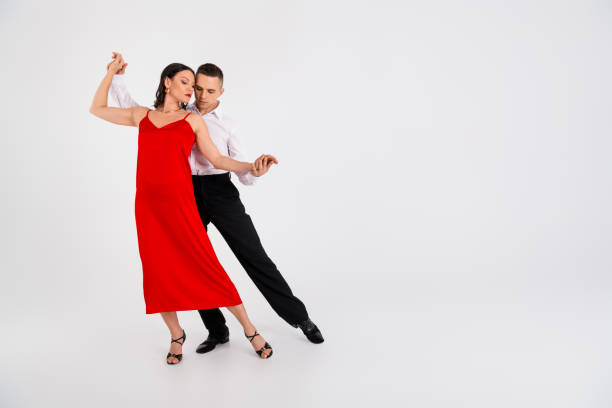 istock Full size photo of two young passionate dancing partners hold arms empty space isolated on white color background 2193827596
