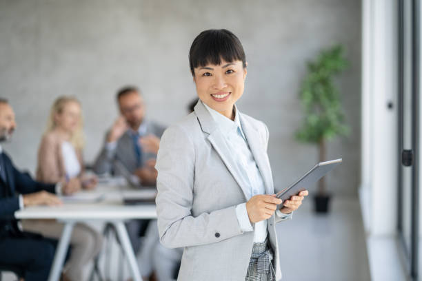 istock Smiling Businesswoman Holding Tablet in Office Setting 2193827980