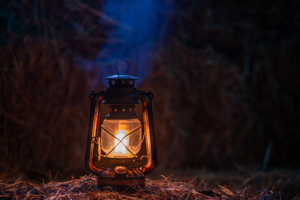 istock antique kerosene lamp with lights on a haystack in a barn at night 2193830565