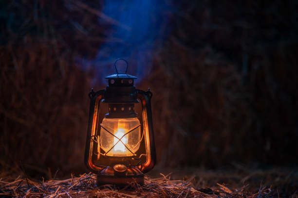 istock antique kerosene lamp with lights on a haystack in a barn at night 2193830676