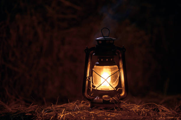 istock antique kerosene lamp with lights on a haystack in a barn at night 2193830851