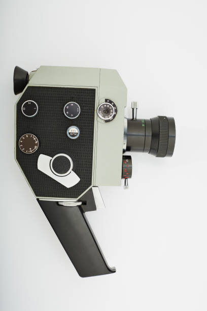 Old fashioned analog 8mm film movie camera on white background