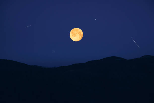 Full Moon, stars, planets, meteor trail and landscape scenery silhouettes.
