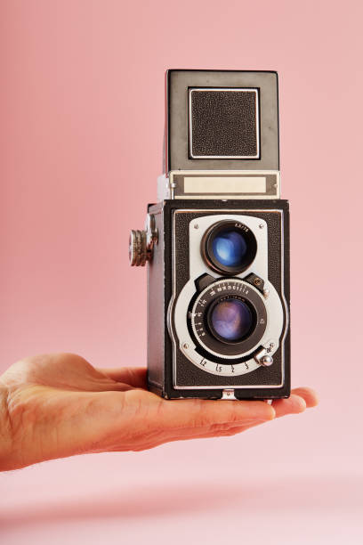 istock Hand holding a vintage twin lens reflex (TLR) medium format camera with waist level finder 2193831748