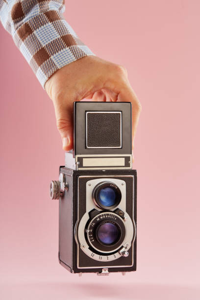 istock Hand holding a vintage twin lens reflex (TLR) medium format camera with waist level finder 2193831749
